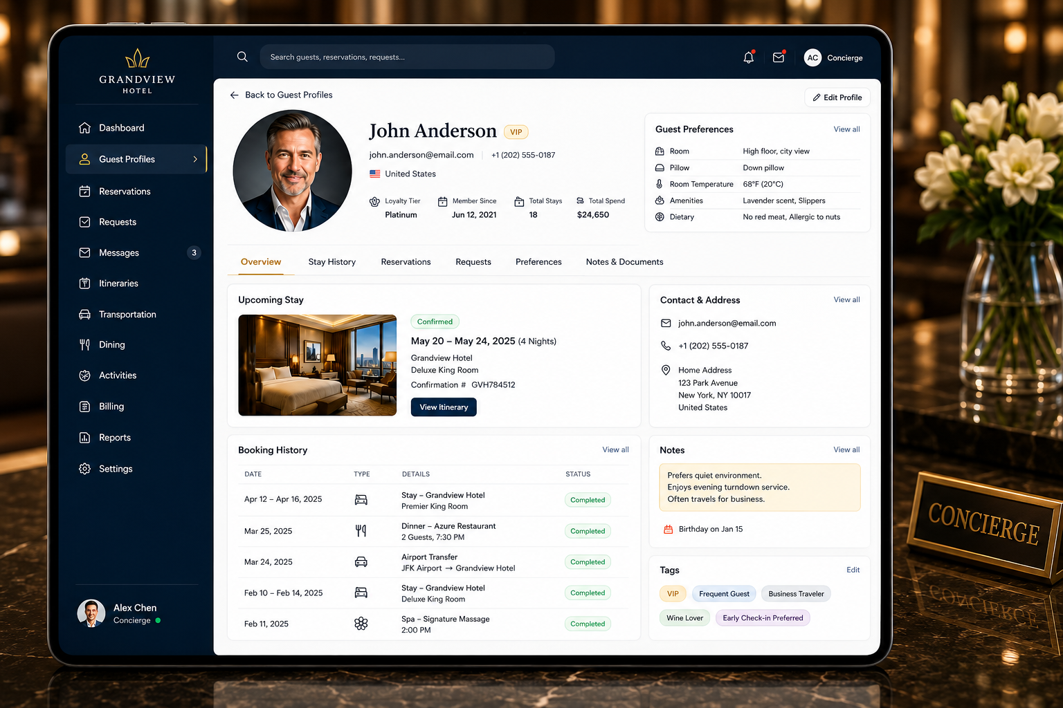 Concierge reviewing guest profiles on a tablet at the front desk