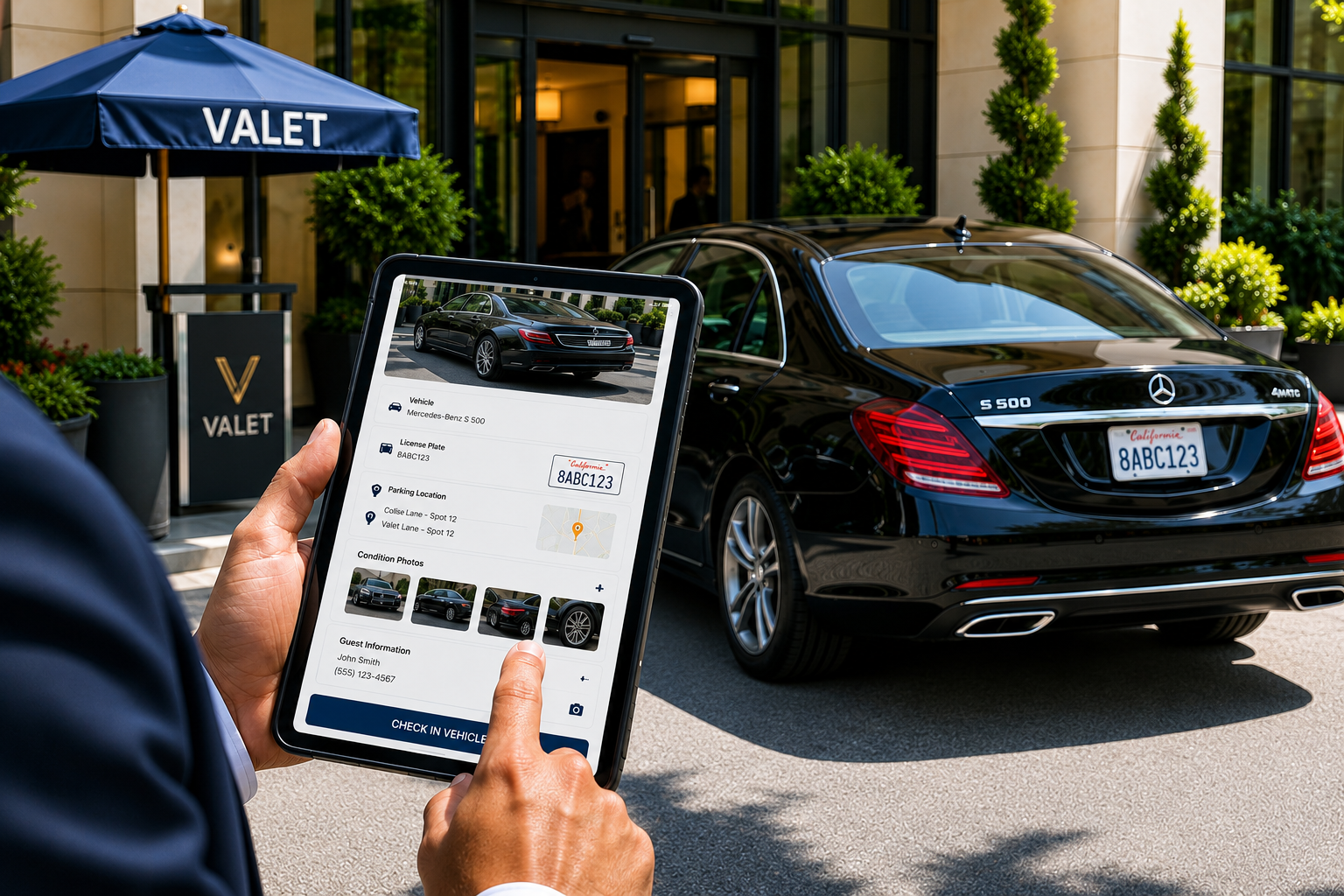 Valet attendant checking in a guest vehicle on a tablet outside a hotel